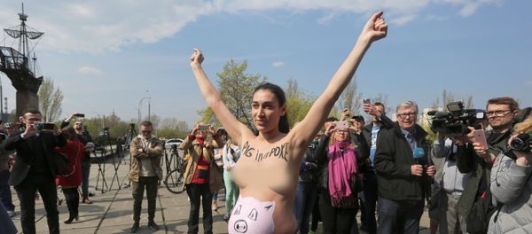 A topless activist of women's rights group Femen protests outside a polling station during the visit of Ukrainian presidential candidate Volodymyr Zelenskiy, who takes part in the second round of a presidential election in Kiev, Ukraine April 21, 2019. A topless activist of women's rights group Femen protests outside a polling station during the visit of Ukrainian presidential candidate Volodymyr Zelenskiy, who takes part in the second round of a presidential election in Kiev, Ukraine April 21, 2019. - Sputnik International