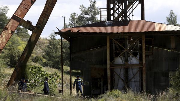 Chief of Cypriot police Zacharias Chrysostomou, second right, walks with Cypriot investigators and police officers at a flooded mineshaft where two female bodies were found, outside Mitsero village near the capital Nicosia, Cyprus, Monday, April 22, 2019. Chief of Cypriot police Zacharias Chrysostomou, second right, walks with Cypriot investigators and police officers at a flooded mineshaft where two female bodies were found, outside Mitsero village near the capital Nicosia, Cyprus, Monday, April 22, 2019. - Sputnik International