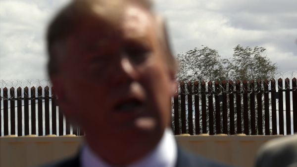 President Donald Trump speaks as he visits a new section of the border wall with Mexico in Calexico, Calif., Friday April 5, 2019 - Sputnik International