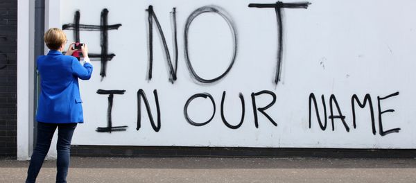A passer by takes a photograph of graffiti on the Creggan estate in Londonderry, which was put up after the murder of Lyra McKee A passer by takes a photograph of graffiti on the Creggan estate in Londonderry, which was put up after the murder of Lyra McKee - Sputnik International