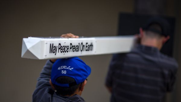 Boys carry a peace pole to an interfaith prayer and candlelight vigil at Rancho Bernardo Community Presbyterian Church on April 27, 2019 in Poway, California. - Sputnik International