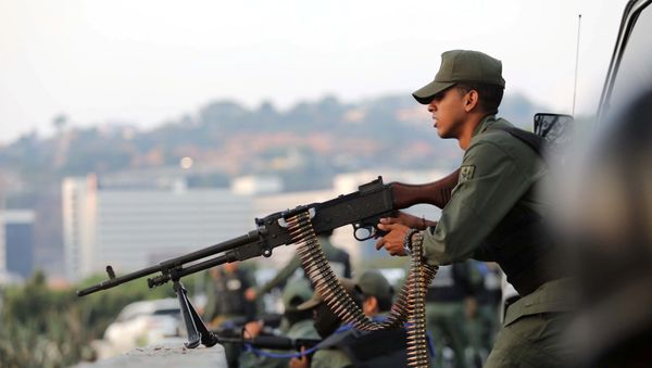 A military member aims a weapon near the Generalisimo Francisco de Miranda Airbase La Carlota, in Caracas, Venezuela April 30, 2019 A military member aims a weapon near the Generalisimo Francisco de Miranda Airbase La Carlota, in Caracas, Venezuela April 30, 2019 - Sputnik International