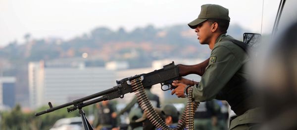 A military member aims a weapon near the Generalisimo Francisco de Miranda Airbase La Carlota, in Caracas, Venezuela April 30, 2019 - Sputnik International