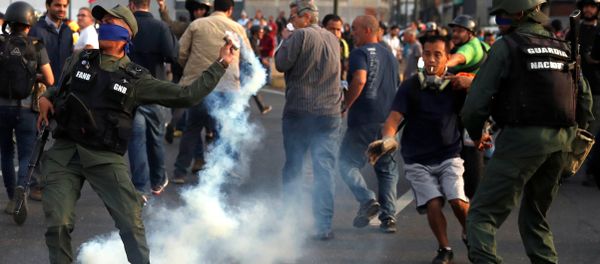 A military member throws a tear gas canister near the Generalisimo Francisco de Miranda Airbase La Carlota, in Caracas, Venezuela April 30, 2019 - Sputnik International