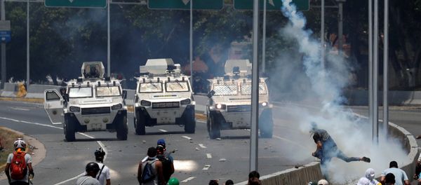 Opposition demonstrators face military vehicles near the Generalisimo Francisco de Miranda Airbase La Carlota in Caracas Opposition demonstrators face military vehicles near the Generalisimo Francisco de Miranda Airbase La Carlota in Caracas - Sputnik International