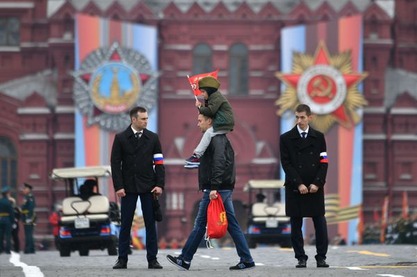 A Man Carrying a Child Before the Victory Day Parade at the Red Square in Moscow A Man Carrying a Child Before the Victory Day Parade at the Red Square in Moscow - Sputnik International