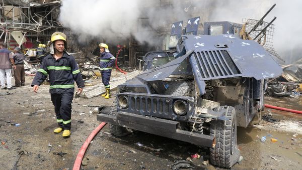 A damaged vehicle of the Iraqi security forces is seen at the site of a car bomb attack in Baghdad al-Jadeeda - Sputnik International