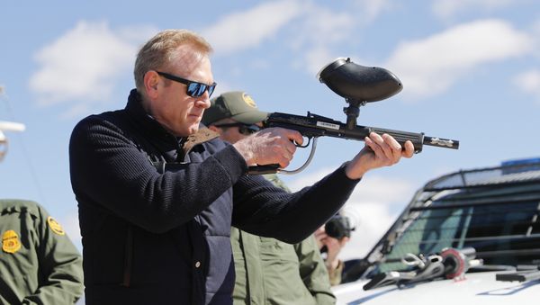 In this Feb. 23, 2019, photo, acting Secretary of Defense Patrick Shanahan, center, fires a modified painted ball gun that shoots pepper balls during a tour of the US-Mexico border at Santa Teresa Station in Sunland Park, N.M., Saturday, Feb. 23, 2019. Shanahan, the former Boeing executive, was in a familiar place, aboard an airplane, when he got word of a bolt-from-the-blue political shot across his bow. A key senator seemed to have buried Shanahan’s chances of being nominated as the next secretary of defense. The crisis passed, but it highlighted the precarious position Shanahan occupies as he waits for President Donald Trump to decide who he will successor to Jim Mattis as leader of the Pentagon. (AP Photo/Pablo Martinez Monsivais) - Sputnik International