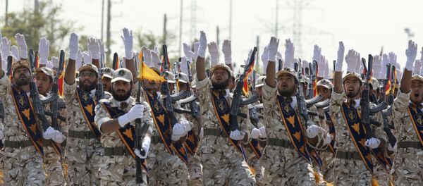 In this Sept. 22, 2011 file photo, Iran's Revolutionary Guard members march during armed forces parade marking the anniversary of the start of the 1980-88 Iraq-Iran war, in front of the shrine of the late revolutionary founder Ayatollah Khomeini, just outside Tehran, Iran In this Sept. 22, 2011 file photo, Iran's Revolutionary Guard members march during armed forces parade marking the anniversary of the start of the 1980-88 Iraq-Iran war, in front of the shrine of the late revolutionary founder Ayatollah Khomeini, just outside Tehran, Iran - Sputnik International