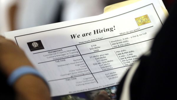A job applicant looks at job listings for the Riverside Hotel at a job fair hosted by Job News South Florida A job applicant looks at job listings for the Riverside Hotel at a job fair hosted by Job News South Florida - Sputnik International