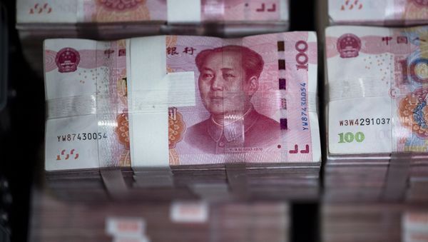 Bundles of 100 yuan notes are pictured at a bank in Shanghai Bundles of 100 yuan notes are pictured at a bank in Shanghai - Sputnik International