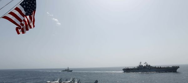 In this Friday, May 17, 2019, photo, released by the U.S. Navy, the amphibious assault ship USS Kearsarge, right, and the Arleigh Burke-class guided-missile destroyer USS Bainbridge, left, are seen from the Nimitz-class aircraft carrier USS Abraham Lincoln as they sail in the Arabian Sea In this Friday, May 17, 2019, photo, released by the U.S. Navy, the amphibious assault ship USS Kearsarge, right, and the Arleigh Burke-class guided-missile destroyer USS Bainbridge, left, are seen from the Nimitz-class aircraft carrier USS Abraham Lincoln as they sail in the Arabian Sea - Sputnik International