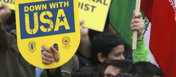 A demonstrator holds an anti-U.S. placard during a ceremony celebrating the 40th anniversary of the Islamic Revolution, at the Azadi, Freedom, Square in Tehran, Iran, Monday, Feb. 11, 2019 A demonstrator holds an anti-U.S. placard during a ceremony celebrating the 40th anniversary of the Islamic Revolution, at the Azadi, Freedom, Square in Tehran, Iran, Monday, Feb. 11, 2019 - Sputnik International