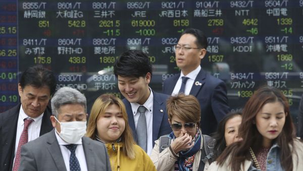 People stand in front of an electronic stock board of a securities firm in Tokyo, Wednesday, April 17, 2019. People stand in front of an electronic stock board of a securities firm in Tokyo, Wednesday, April 17, 2019. - Sputnik International
