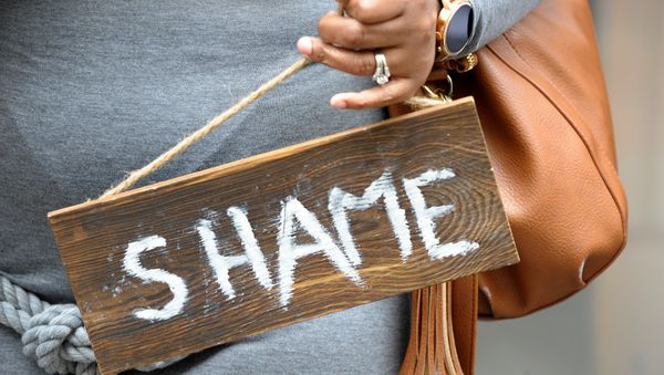 Chandra Craven, 42, dressed as Septa Unella, holds a shame sign from the show while waiting in line at a HBO Game of Thrones final season promotional event at Primark Boston where people could sit in a replica of the Iron Throne from the show on Friday April 19, 2019 in Boston, Ma. - Sputnik International