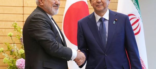 Iranian Foreign Minister Mohammad Javad Zarif, left, and Japanese Prime Minister Shinzo Abe, right, shake hands at Abe's official residence in Tokyo Thursday, May 16, 2019 Iranian Foreign Minister Mohammad Javad Zarif, left, and Japanese Prime Minister Shinzo Abe, right, shake hands at Abe's official residence in Tokyo Thursday, May 16, 2019 - Sputnik International