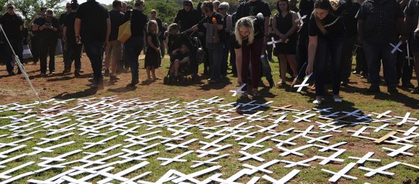 People place white crosses, representing farmers killed in the country, at a ceremony at the Vorrtrekker Monument in Pretoria People place white crosses, representing farmers killed in the country, at a ceremony at the Vorrtrekker Monument in Pretoria - Sputnik International