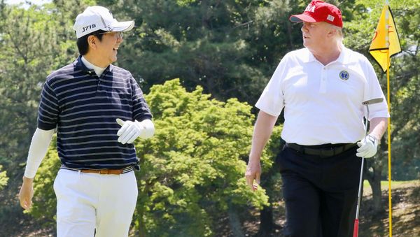 U.S. President Donald Trump talks with Japanese Prime Minister Shinzo Abe as they play golf at Mobara Country Club in Mobara, Chiba prefecture, Japan, in this photo released by Japan's Cabinet Public Relations Office via Kyodo May 26, 2019 - Sputnik International