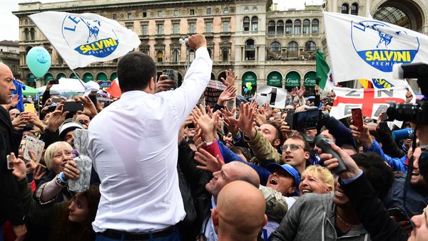 Italian Deputy Prime Minister and Interior Minister Matteo Salvini (C) greets supporters during a rally of European nationalists ahead of European elections on May 18, 2019, in Milan Italian Deputy Prime Minister and Interior Minister Matteo Salvini (C) greets supporters during a rally of European nationalists ahead of European elections on May 18, 2019, in Milan - Sputnik International