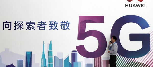A man talks on his mobile phone beside Huawei's billboard featuring 5G technology at the PT Expo in Beijing, China, September 26, 2018 - Sputnik International