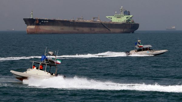 Iranian Revolutionary Guard speedboats cruise past an oil tanker off the port of Bandar Abbas, southern Iran, on July 2, 2012 Iranian Revolutionary Guard speedboats cruise past an oil tanker off the port of Bandar Abbas, southern Iran, on July 2, 2012 - Sputnik International