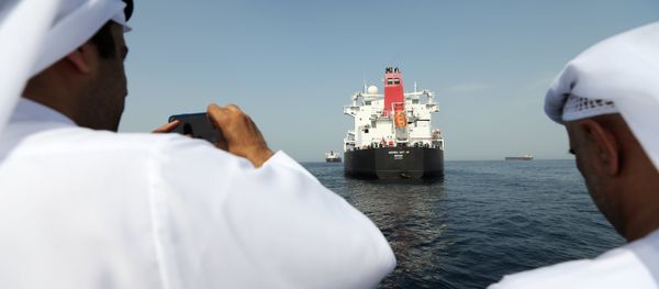 Port officials take a photo of a damaged Andrea Victory ship at the Port of Fujairah, United Arab Emirates, May 13, 2019 - Sputnik International