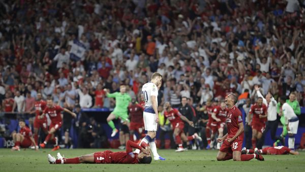 Tottenham's Harry Kane walks past Liverpool's players as they celebrate after winning the Champions League final soccer match against Tottenham Hotspur at the Wanda Metropolitano Stadium in Madrid, Saturday, June 1, 2019. - Sputnik International