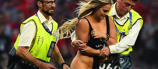 Stewards escort a pitch invader during the UEFA Champions League final football match between Liverpool and Tottenham Hotspur at the Wanda Metropolitano Stadium in Madrid on June 1, 2019 - Sputnik International