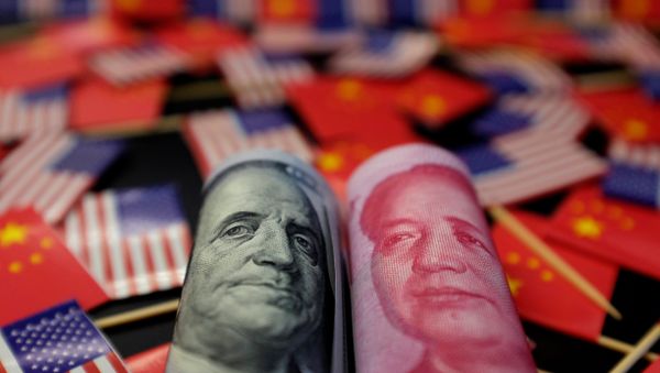 A US dollar banknote featuring American founding father Benjamin Franklin and a China's yuan banknote featuring late Chinese chairman Mao Zedong are seen among US and Chinese flags in this illustration picture taken 20 May, 2019 - Sputnik International