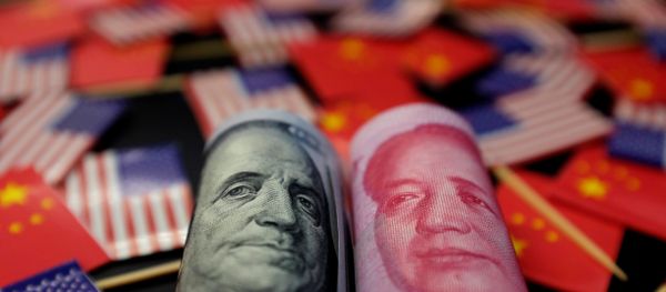A US dollar banknote featuring American founding father Benjamin Franklin and a China's yuan banknote featuring late Chinese chairman Mao Zedong are seen among US and Chinese flags in this illustration picture taken 20 May, 2019 A US dollar banknote featuring American founding father Benjamin Franklin and a China's yuan banknote featuring late Chinese chairman Mao Zedong are seen among US and Chinese flags in this illustration picture taken 20 May, 2019 - Sputnik International