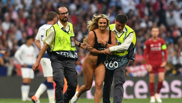 Security escort a pitch invader during the UEFA Champions League final football match between Liverpool and Tottenham Hotspur at the Wanda Metropolitan Stadium in Madrid on June 1, 2019 - Sputnik International