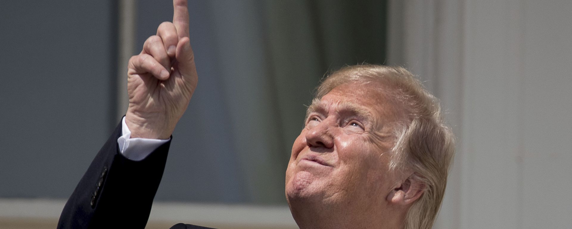 President Donald Trump points to the sun as he arrives to view the solar eclipse, Monday, Aug. 21, 2017, at the White House in Washington. - Sputnik International, 1920, 23.01.2024