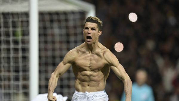 Real Madrid's Portuguese forward Cristiano Ronaldo celebrates after scoring a penalty during the UEFA Champions League quarter-final second leg football match between Real Madrid CF and Juventus FC at the Santiago Bernabeu stadium in Madrid on April 11, 2018.  - Sputnik International