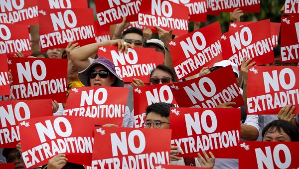 Protesters hold placards as they stage protest against the extradition law in Hong Kong, Sunday, June 9, 2019 Protesters hold placards as they stage protest against the extradition law in Hong Kong, Sunday, June 9, 2019 - Sputnik International
