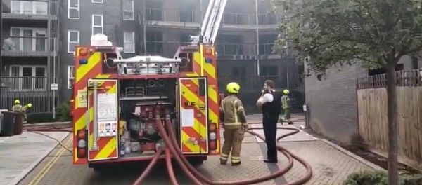 Dozens of firefighters were called to the scene on Sunday as a fire broke out at a new apartment block in the east of the British capital Dozens of firefighters were called to the scene on Sunday as a fire broke out at a new apartment block in the east of the British capital - Sputnik International