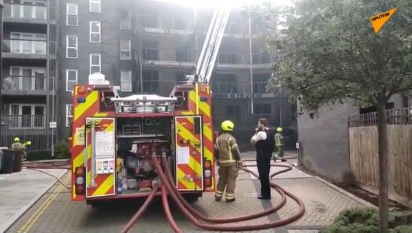 Dozens of firefighters were called to the scene on Sunday as a fire broke out at a new apartment block in the east of the British capital - Sputnik International