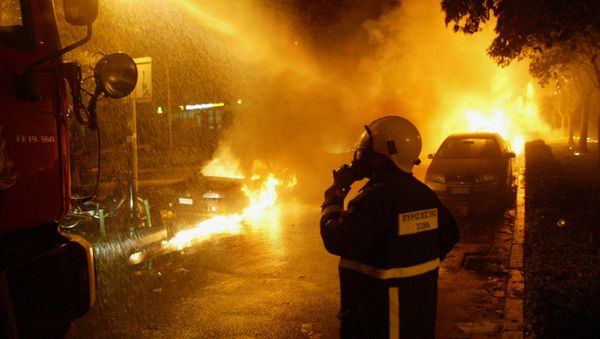 Firefighters try to extinguish a fire during a in the northern Greek port city of Thessaloniki (File) Firefighters try to extinguish a fire during a in the northern Greek port city of Thessaloniki (File) - Sputnik International