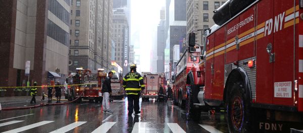 New York City Fire Department trucks and firefighters are seen outside 787 7th Avenue in midtown Manhattan where a helicopter was reported to have crashed in New York City, New York, U.S., June 10, 2019. REUTERS/Brendan McDermid - Sputnik International