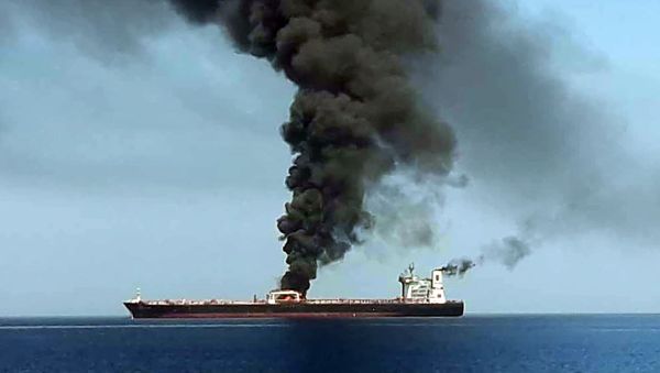 A picture obtained by AFP from Iranian State TV IRIB on June 13, 2019 reportedly shows smoke billowing from a tanker said to have been attacked off the coast of Oman, at un undisclosed location - Sputnik International