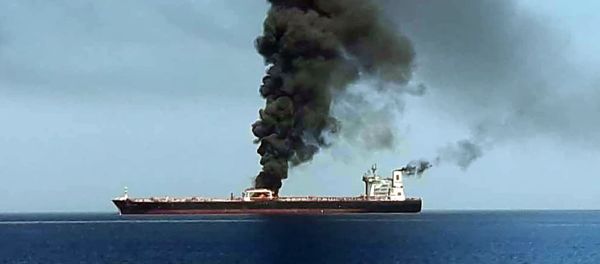 A picture obtained by AFP from Iranian State TV IRIB on June 13, 2019 reportedly shows smoke billowing from a tanker said to have been attacked off the coast of Oman, at un undisclosed location - Sputnik International