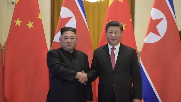 In this Tuesday, Jan. 8, 2019, photo released by China's Xinhua News Agency, North Korean leader Kim Jong-un, left, and Chinese President Xi Jinping shake hands as they pose for a photo before talks at the Great Hall of the People in Beijing. - Sputnik International