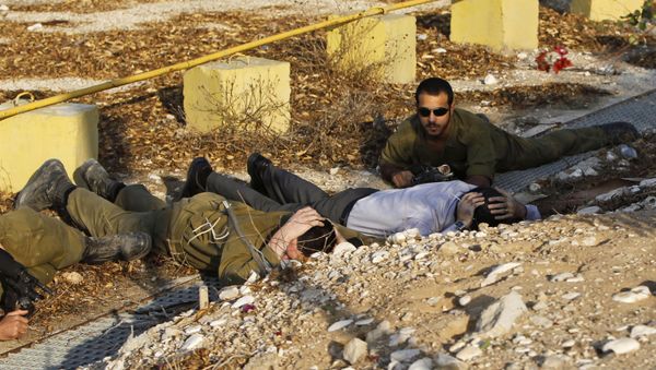 Israeli soldiers and a civilian take cover as a siren alerting of an incoming rocket from Gaza Strip sounds in Ofakim, southern Israel (File) - Sputnik International