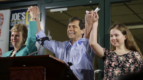 Former Congressman Joe Sestak, center, his wife Susan Sestak, left, and daughter Alex Sestak react after speaking to supporters gathered outside his campaign headquarters - Sputnik International