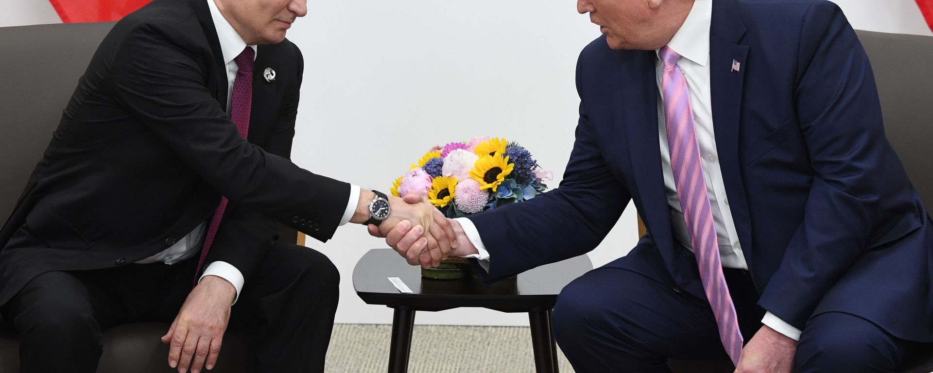 Russian President Vladimir Putin and U.S. President Donald Trump shake hands during a bilateral meeting at the at the Group of 20 (G20) leaders summit in Osaka, Japan. - Sputnik International, 1920, 21.05.2025