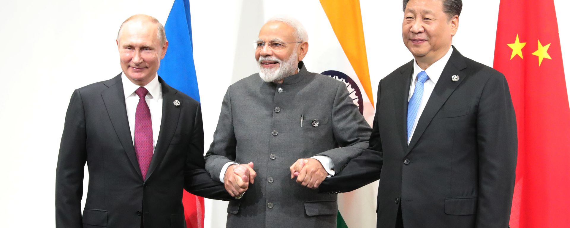 Russian President Vladimir Putin, India's Prime Minister Narendra Modi and Chinese President Xi Jinping pose for a photo during a meeting on the sidelines of the Group of 20 (G20) leaders summit in Osaka, Japan Russian President Vladimir Putin, India's Prime Minister Narendra Modi and Chinese President Xi Jinping pose for a photo during a meeting on the sidelines of the Group of 20 (G20) leaders summit in Osaka, Japan - Sputnik International, 1920, 06.12.2025