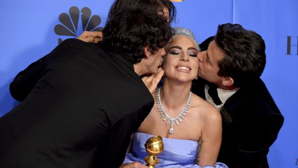 Anthony Rossomando, from left, Andrew Wyatt, and Mark Ronson, right, kiss Lady Gaga, second right, as they pose in the press room with the award for best original song, motion picture for Shallow from the film A Star Is Born at the 76th annual Golden Globe Awards - Sputnik International
