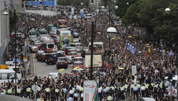 Police block the road ahead of a march by protesters in Hong Kong on Sunday, July 7, 2019. Police block the road ahead of a march by protesters in Hong Kong on Sunday, July 7, 2019. - Sputnik International