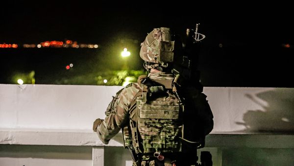 A British soldier looks on during an operation involving the oil supertanker Grace 1, that's on suspicion of carrying Iranian crude oil to Syria, in waters off the British overseas territory of Gibraltar, historically claimed by Spain, July 4, 2019 - Sputnik International