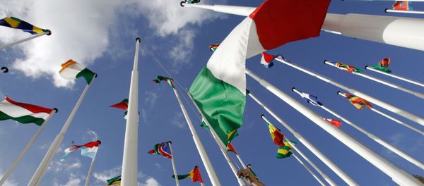 A worker hoists Italy's flag along with the flags of the European Union and African countries participating in the EU-Africa summit Friday, Dec. 7, 2007, in Lisbon A worker hoists Italy's flag along with the flags of the European Union and African countries participating in the EU-Africa summit Friday, Dec. 7, 2007, in Lisbon - Sputnik International
