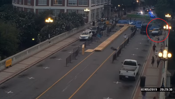 Hilmary Moreno-Berrios travels down downtown Greenville’s Main Street area in a stolen Honda CR-V, plowing through barricades set up for the annual Liberty Bridge Jump-Off pole vaulting competition, Friday , July 5, 2019 - Sputnik International